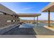 Modern pool with desert landscaping and an open air cabana with views of the city at 11 Cloud Chaser Blvd, Henderson, NV 89012