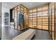 Custom walk-in closet features expansive shelving, modern cabinetry, and full-size, front-load washer and dryer at 11 Cloud Chaser Blvd, Henderson, NV 89012