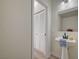 Powder room featuring pedestal sink, framed mirror, and closet at 11159 African Sunset St, Henderson, NV 89052