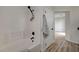 Bathroom with white tiled shower and tub combination at 11159 African Sunset St, Henderson, NV 89052