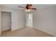 A carpeted bedroom featuring a ceiling fan and closet at 11159 African Sunset St, Henderson, NV 89052