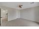 Bedroom with neutral carpet, ceiling fan, and ensuite bathroom access at 11159 African Sunset St, Henderson, NV 89052