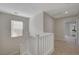 Upstairs hallway featuring neutral carpet and paint at 11159 African Sunset St, Henderson, NV 89052