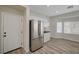 Bright kitchen featuring stainless steel refrigerator and wood-look flooring at 11159 African Sunset St, Henderson, NV 89052