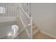 Carpeted staircase with white wood banister and railing at 11159 African Sunset St, Henderson, NV 89052