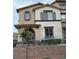 Charming two-story townhome with neutral stucco, gray shutters, and a well-maintained front yard at 11489 Belmont Lake Dr # 106, Las Vegas, NV 89135
