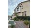 Multi-story townhome showcasing landscaped front yard and appealing architectural details at 11489 Belmont Lake Dr # 106, Las Vegas, NV 89135