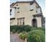 Attractive two-story townhome featuring arched entryway, landscaped front yard, and neutral color scheme at 11489 Belmont Lake Dr # 106, Las Vegas, NV 89135