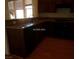 Kitchen featuring dark wood cabinets, dark appliances, and granite countertops at 11489 Belmont Lake Dr # 106, Las Vegas, NV 89135