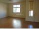 Bright living room with hardwood floors and natural light from windows at 11489 Belmont Lake Dr # 106, Las Vegas, NV 89135