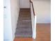 Carpeted staircase with white railing leading to the upper level of the home at 11489 Belmont Lake Dr # 106, Las Vegas, NV 89135