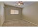 Bright bedroom with plush carpet, ceiling fan, closet, and a window that brings in natural light at 12045 Yarrow Ridge Ct, Las Vegas, NV 89183
