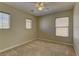 Inviting bedroom with neutral carpet and multiple windows, creating a cozy and bright atmosphere at 12045 Yarrow Ridge Ct, Las Vegas, NV 89183