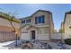 Attractive two-story home showcases a well-maintained front yard with rock features and blue shutters at 12045 Yarrow Ridge Ct, Las Vegas, NV 89183