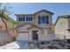 Charming two-story home with a front yard featuring decorative rock landscaping and blue shutters at 12045 Yarrow Ridge Ct, Las Vegas, NV 89183