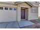 Close-up of the home's entrance, highlighting the front door and attached two car garage at 12045 Yarrow Ridge Ct, Las Vegas, NV 89183