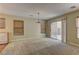 Open living room with a dining area featuring wood floors, large sliding door, and neutral wall paint at 12045 Yarrow Ridge Ct, Las Vegas, NV 89183