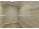 Organized walk-in closet with multiple shelves, providing ample storage space and functionality at 12045 Yarrow Ridge Ct, Las Vegas, NV 89183
