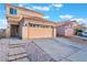 Charming home displaying its neutral color palette, tile roof and attached two-car garage at 1312 Pacific Terrace Dr, Las Vegas, NV 89128