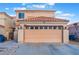 Charming home displaying its neutral color palette, tile roof and attached two-car garage at 1312 Pacific Terrace Dr, Las Vegas, NV 89128