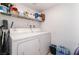 Efficient laundry room with appliances and shelving for organizing supplies at 1312 Pacific Terrace Dr, Las Vegas, NV 89128