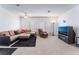 Bright living room with a large sectional sofa, recliner, ceiling fan, and entertainment center at 1312 Pacific Terrace Dr, Las Vegas, NV 89128
