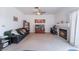 Inviting living room with a cozy fireplace, comfortable sofa, and a ceiling fan at 1312 Pacific Terrace Dr, Las Vegas, NV 89128