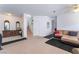 Spacious living room showing a sofa, tile flooring, carpeted stairs and a ceiling fan at 1312 Pacific Terrace Dr, Las Vegas, NV 89128