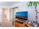 Cozy living room featuring a large flat-screen TV and bright natural light at 1312 Pacific Terrace Dr, Las Vegas, NV 89128