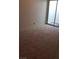 Carpeted bedroom showcasing a large sliding glass door to an enclosed patio at 2021 San Simeon St, Las Vegas, NV 89108