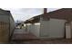 Exterior view of the house, showing side windows, concrete patio, and alley access at 2021 San Simeon St, Las Vegas, NV 89108