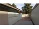 Exterior view of the house, showing side of home, concrete patio, and cinder block wall at 2021 San Simeon St, Las Vegas, NV 89108
