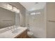 Bright bathroom with a tiled shower-over-tub and a marble countertop with chrome fixtures at 2061 Smoketree Village Cir, Henderson, NV 89012