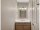 Half bathroom with modern vanity, attractive mirror, and updated fixtures at 2061 Smoketree Village Cir, Henderson, NV 89012