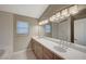 Bathroom showcasing a long vanity with double sinks and bright lighting at 2061 Smoketree Village Cir, Henderson, NV 89012