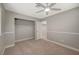 Cozy bedroom with neutral carpet, a ceiling fan, and a closet at 2061 Smoketree Village Cir, Henderson, NV 89012