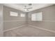 Carpeted bedroom featuring neutral walls, white trim, and a ceiling fan at 2061 Smoketree Village Cir, Henderson, NV 89012