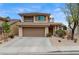 Inviting two-story home features a well-manicured yard and attached two-car garage at 2061 Smoketree Village Cir, Henderson, NV 89012