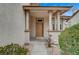 Inviting front entryway featuring a covered porch and classic front door at 2061 Smoketree Village Cir, Henderson, NV 89012