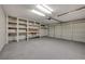 Spacious garage with storage shelving and an epoxy-coated floor at 2061 Smoketree Village Cir, Henderson, NV 89012