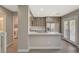 Modern kitchen with stainless steel appliances, stone countertops, and natural light at 2061 Smoketree Village Cir, Henderson, NV 89012