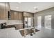 Bright kitchen featuring stainless steel appliances and stone countertops at 2061 Smoketree Village Cir, Henderson, NV 89012