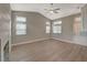 Spacious living room with hardwood floors, plenty of natural light, and a fireplace at 2061 Smoketree Village Cir, Henderson, NV 89012