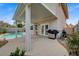 Covered patio with a built-in grill area, ideal for outdoor cooking and dining overlooking the pool at 2061 Smoketree Village Cir, Henderson, NV 89012