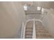 View from the top of a carpeted staircase overlooking the downstairs living area at 2061 Smoketree Village Cir, Henderson, NV 89012