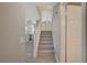 Bright staircase leading to the second floor with gray carpet and white railing at 2061 Smoketree Village Cir, Henderson, NV 89012