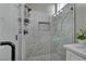 Modern bathroom with white marble walk-in shower featuring black hardware and stylish niche at 2345 Hot Brook Point St, Las Vegas, NV 89134