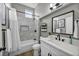 Bright bathroom featuring a shower over bath, elegant vanity, and neutral color scheme at 2345 Hot Brook Point St, Las Vegas, NV 89134