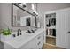 Stylish bathroom with double sinks, modern fixtures, and a well-organized closet at 2345 Hot Brook Point St, Las Vegas, NV 89134