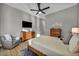 Cozy bedroom with bright natural light, a comfortable chair, and wooden furniture at 2345 Hot Brook Point St, Las Vegas, NV 89134